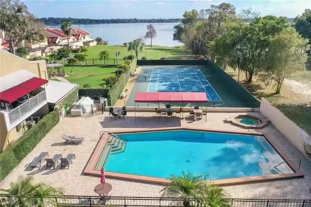 1 Casarena Ct, Winter Haven, FL 33881 - pool featuring a water view, a patio area, fence, and a hot tub