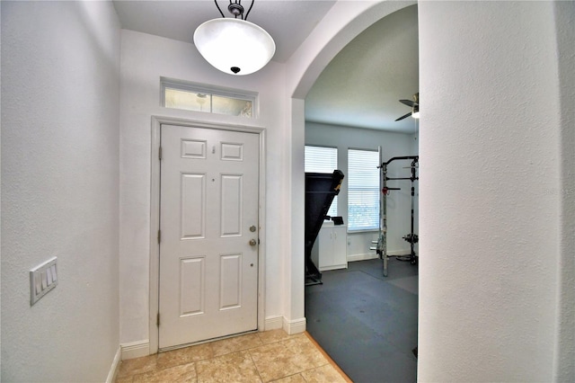 tiled entryway with ceiling fan