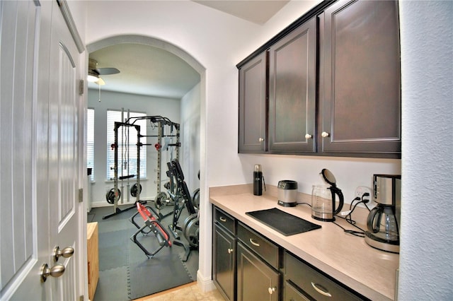 kitchen with dark brown cabinetry and ceiling fan