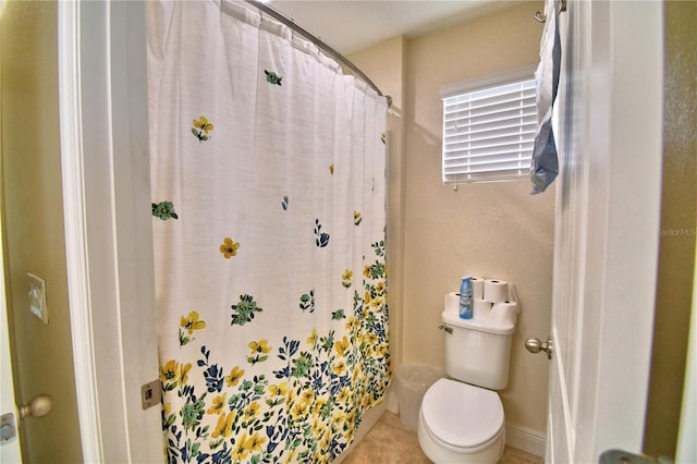 bathroom with toilet and curtained shower