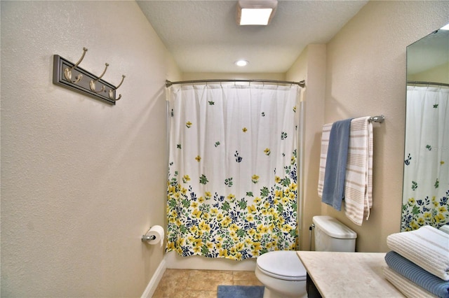 bathroom featuring walk in shower, vanity, toilet, and tile patterned flooring