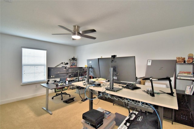 home office with ceiling fan and light carpet