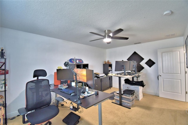 home office featuring a textured ceiling, light colored carpet, and ceiling fan