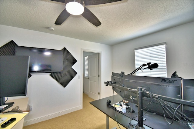 miscellaneous room featuring a textured ceiling, light colored carpet, and ceiling fan