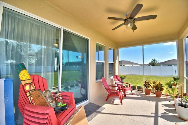 sunroom / solarium featuring ceiling fan