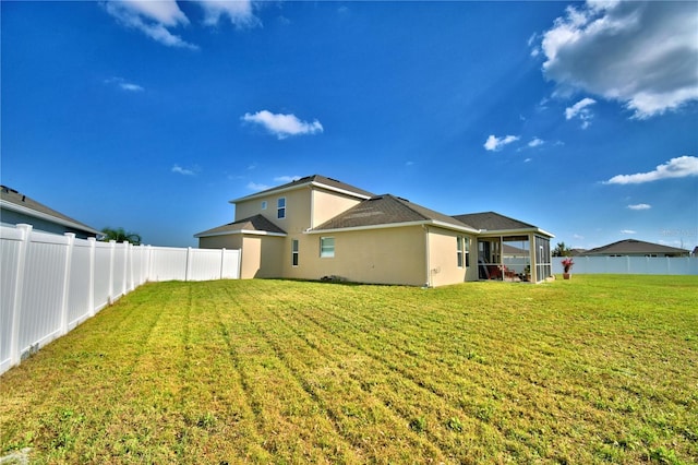 rear view of house with a yard