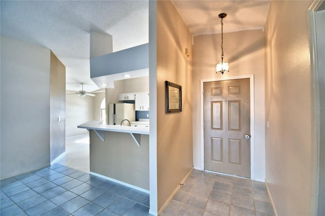 tiled foyer entrance with ceiling fan