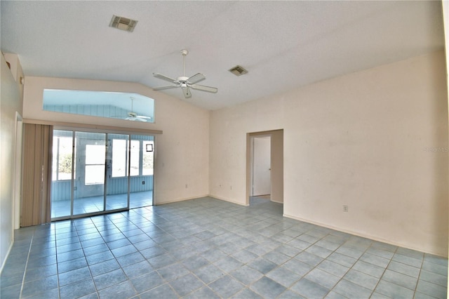 tiled empty room with vaulted ceiling and ceiling fan