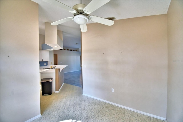 interior space featuring ceiling fan and sink