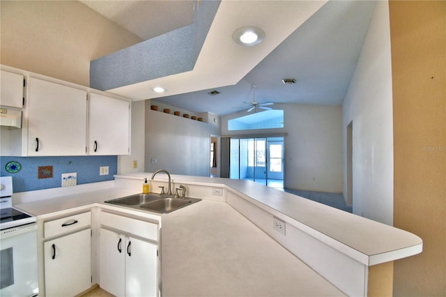 kitchen featuring white cabinetry, sink, white electric stove, and kitchen peninsula