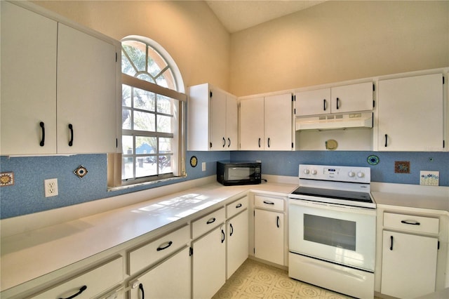 kitchen with backsplash, white cabinets, a wealth of natural light, and electric range