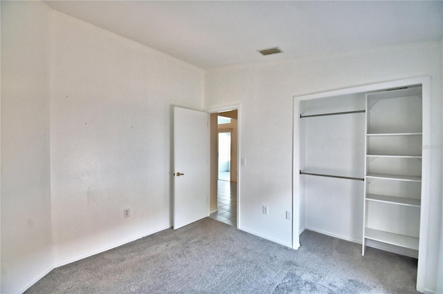 unfurnished bedroom featuring carpet floors and a closet