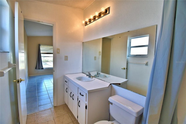 bathroom featuring tile patterned floors, toilet, and vanity