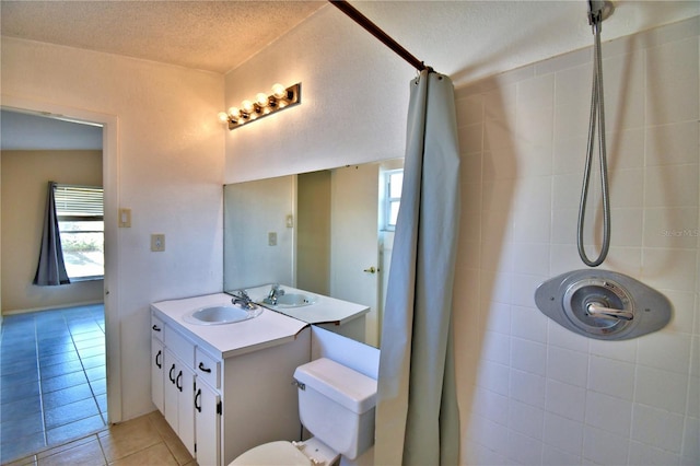 bathroom with vanity, toilet, tile patterned floors, a textured ceiling, and a shower with shower curtain