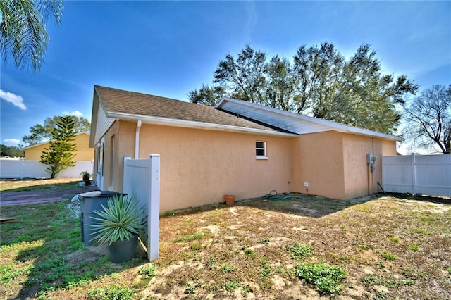 view of side of property with a lawn