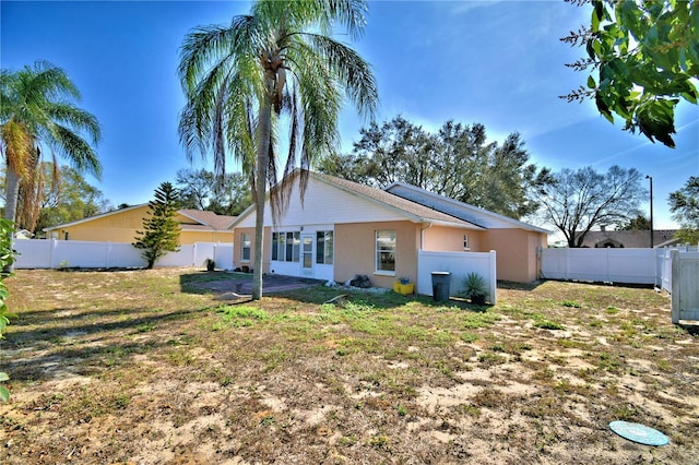 rear view of house featuring a yard