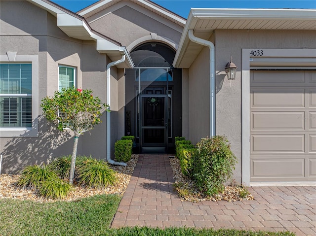 doorway to property with a garage