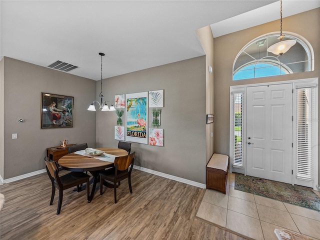 foyer entrance featuring light hardwood / wood-style floors and a chandelier