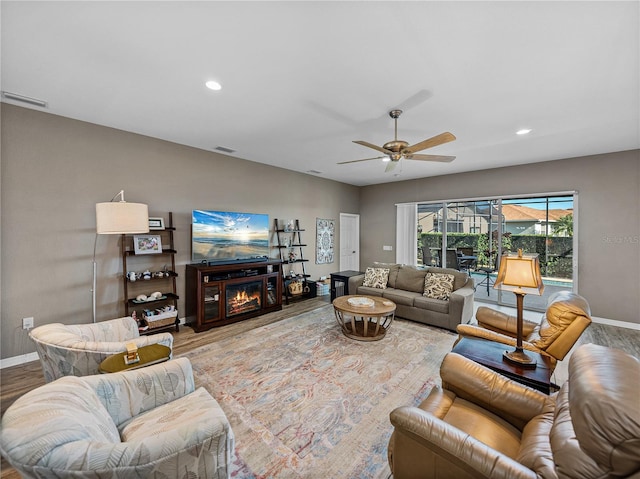 living room featuring hardwood / wood-style flooring and ceiling fan