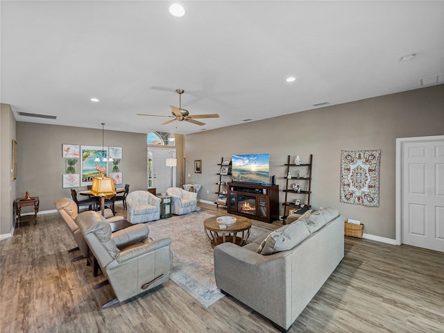 living room featuring wood-type flooring and ceiling fan