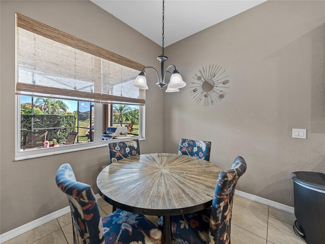 tiled dining room with an inviting chandelier