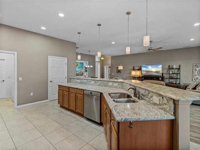 kitchen featuring dishwasher, sink, hanging light fixtures, a large island with sink, and light stone counters