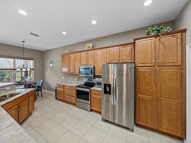 kitchen featuring light tile patterned flooring, sink, appliances with stainless steel finishes, a notable chandelier, and pendant lighting