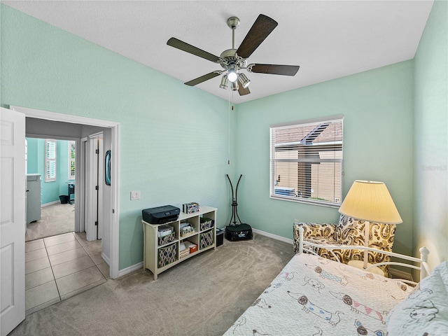 bedroom with ceiling fan and light carpet