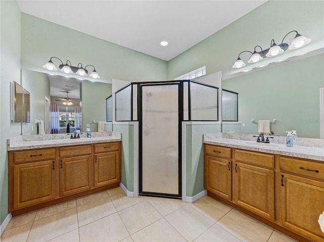 bathroom featuring tile patterned floors, vanity, and a shower with door