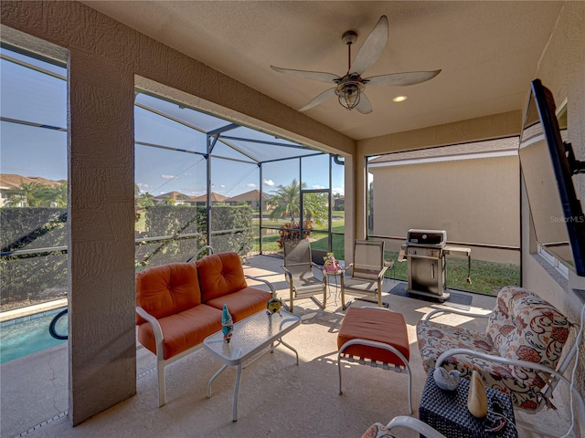 sunroom / solarium featuring ceiling fan