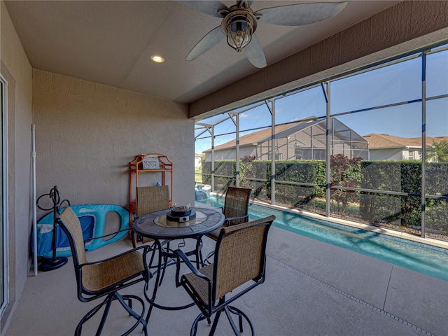 view of patio / terrace with a fenced in pool, a lanai, and ceiling fan