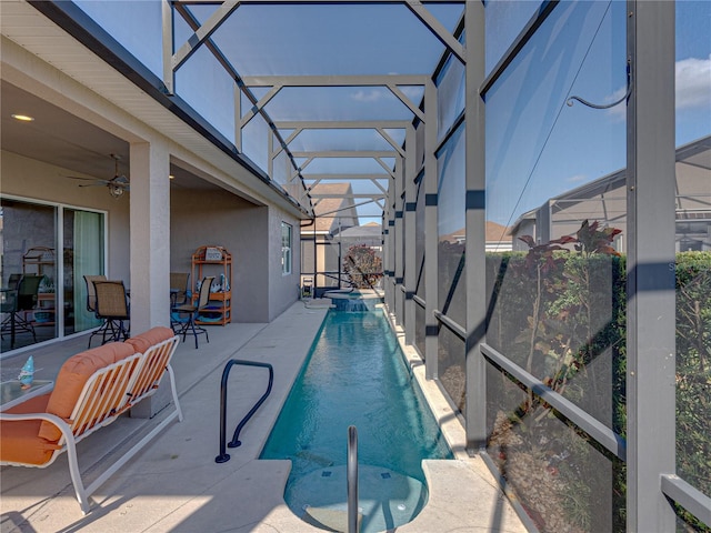 view of pool featuring a lanai, ceiling fan, and a patio area