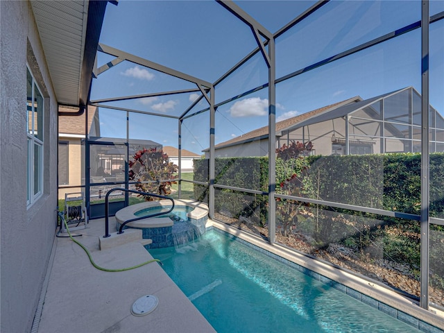 view of pool with a patio area, glass enclosure, and an in ground hot tub