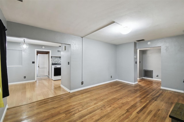 spare room with hardwood / wood-style floors