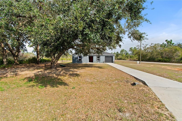 view of front of home featuring a garage and a front lawn