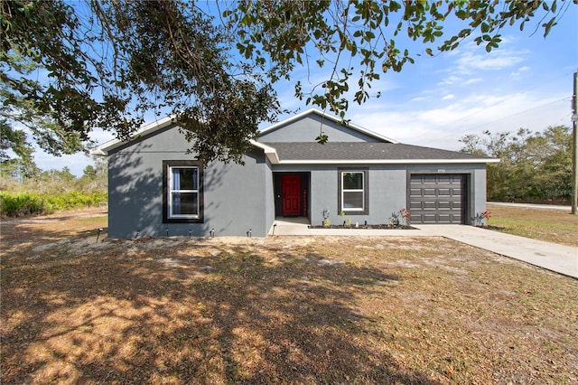 single story home with a garage and a front yard