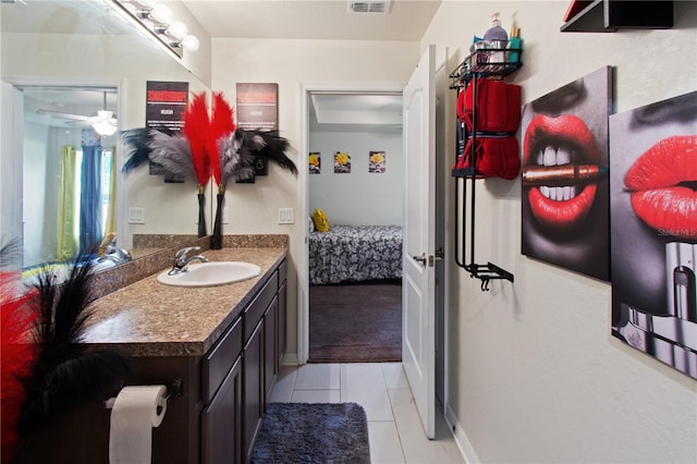 bathroom with tile patterned flooring, vanity, and ceiling fan