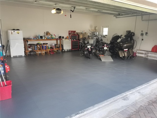 garage featuring a garage door opener and white fridge