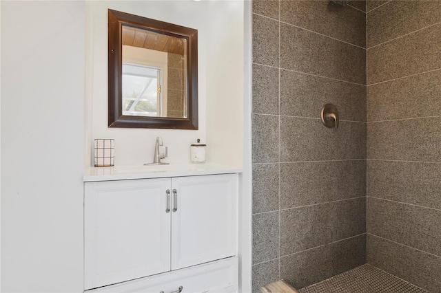 bathroom with vanity and tiled shower