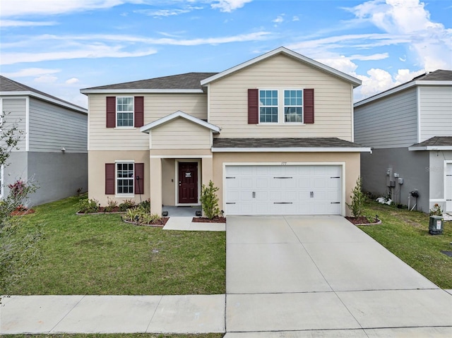 view of front property featuring a garage and a front yard