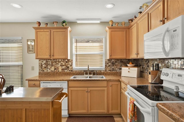 kitchen with sink, backsplash, and white appliances