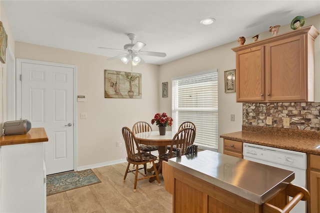 kitchen featuring white dishwasher, backsplash, light tile patterned floors, and ceiling fan