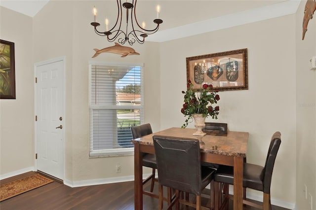 dining space featuring dark wood-type flooring and an inviting chandelier