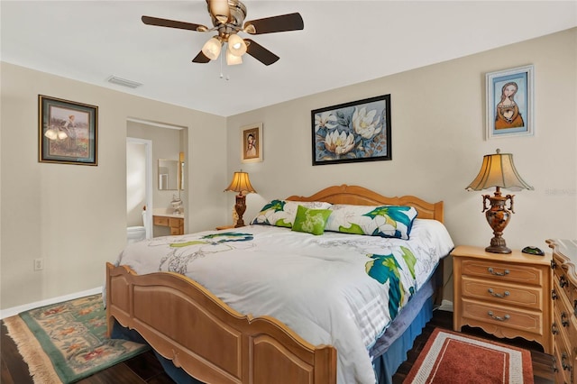 bedroom with dark wood-type flooring, ceiling fan, and ensuite bathroom