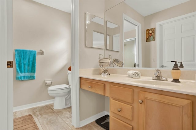 bathroom featuring vanity, tile patterned floors, and toilet