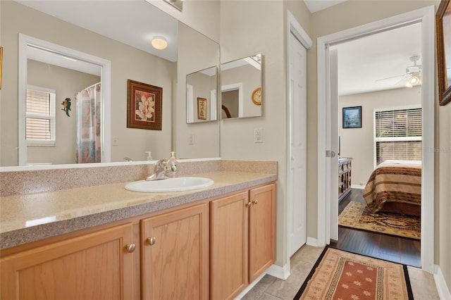 bathroom with ceiling fan and vanity