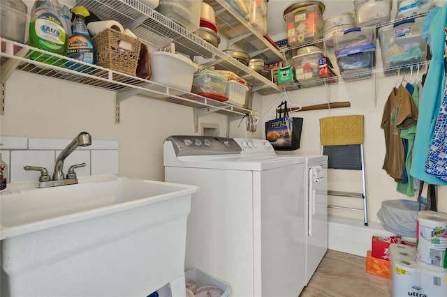 washroom featuring washing machine and dryer and sink