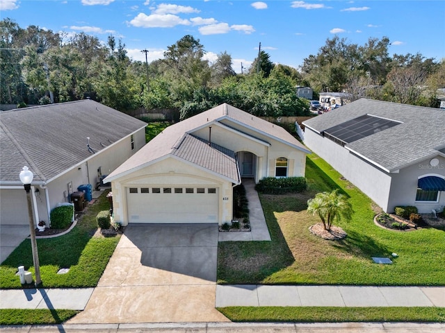 view of front of home with a garage and a front yard