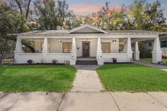 view of front of house featuring covered porch and a front yard