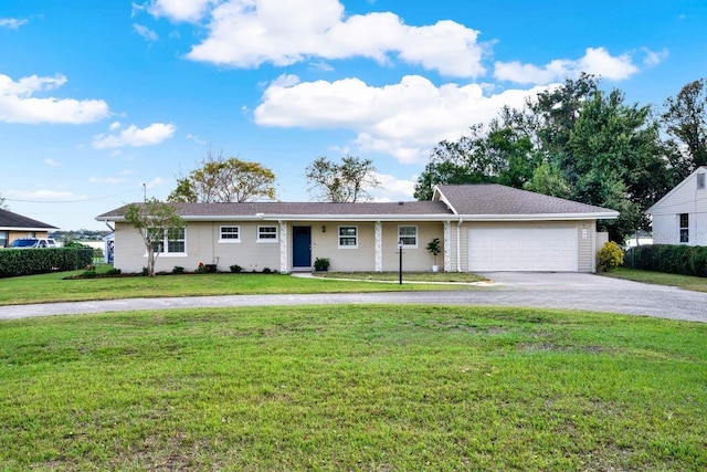 ranch-style house featuring a garage and a front yard